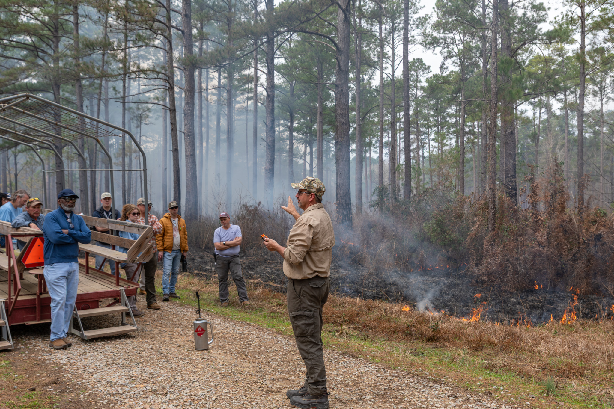 Man leads a workshop in the forest.